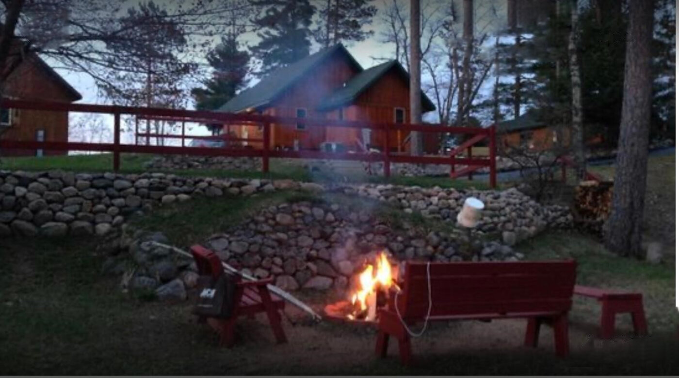 Fire pit with cabins at dusk